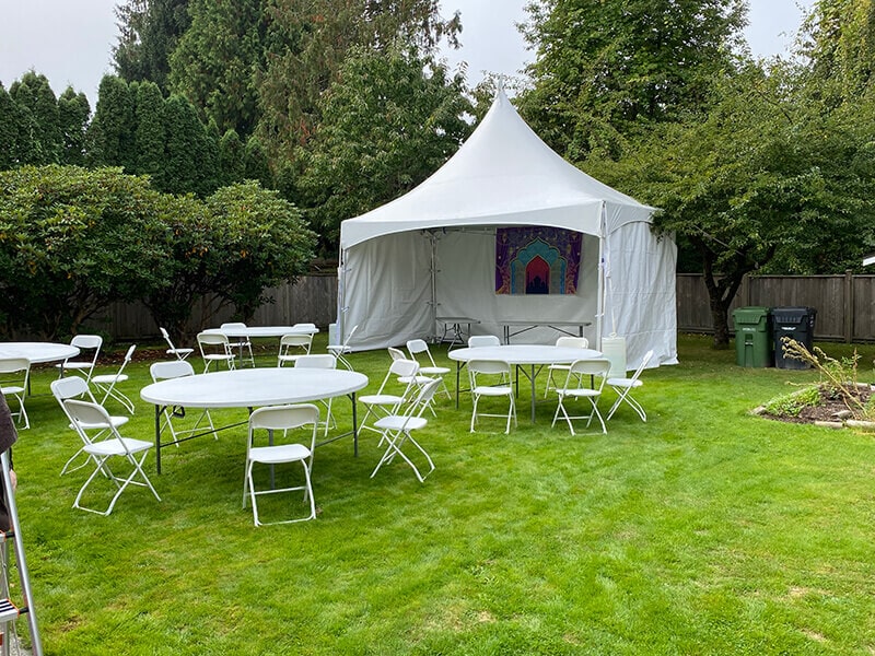 Backyard event with table and chair rentals